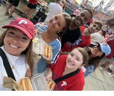 A group of six summer associates enjoying a Phillies game.