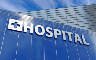 blue facade of a hospital sign against blue sky