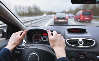 woman holding steering wheel in traffic photo